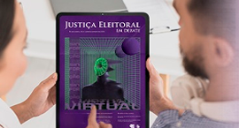 Um homem e uma mulher seguram um tablet que exibe a capa da revista "Justiça Eleitoral em Debate...