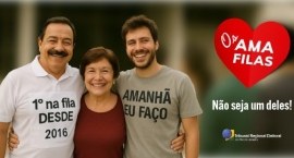 Três pessoas sorriem lado a lado em um ambiente externo. À esquerda, um homem de bigode usa uma ...