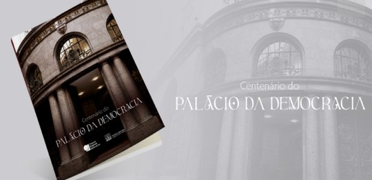 A imagem apresenta a capa do livro “Centenário do Palácio da Democracia (1926–2026)” inclinado s...