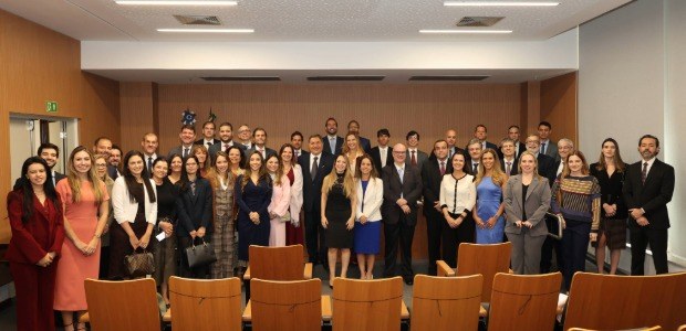 Grupo de magistradas e magistrados posam para foto oficial ao final da cerimônia de posse, em au...